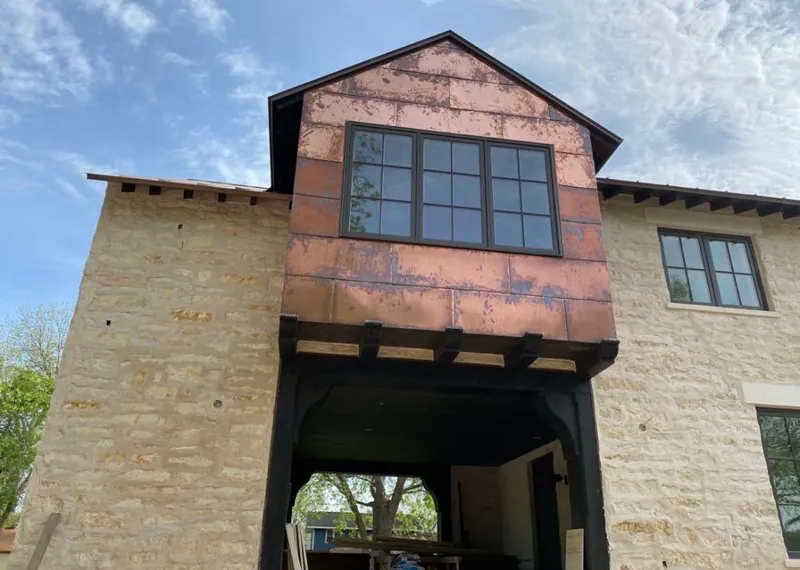 Copper metal panel facade on a stone building for Metal Roof Coating in Farmington
